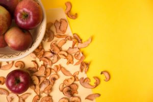 apple chips on yellow table backdrop