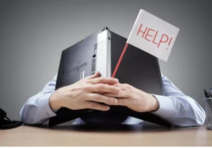 laptop over head in resignation flag in hand says 'help!'