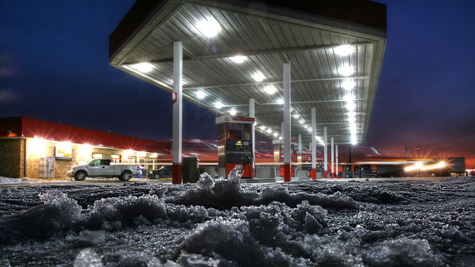 gas station bright lights view from ground ominous bright