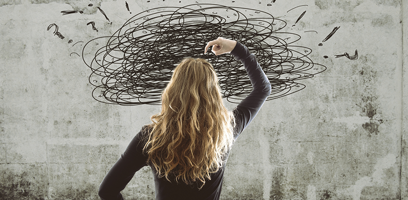 backside of woman scratching head at complex scribble